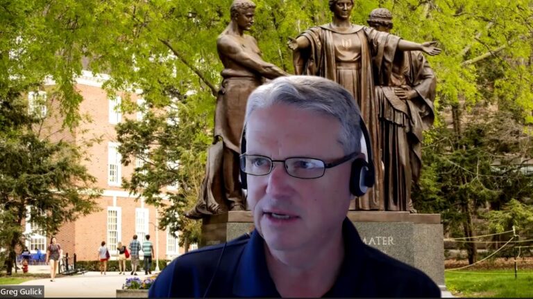 Greg Gulick presents on Zoom with alma mater in the background