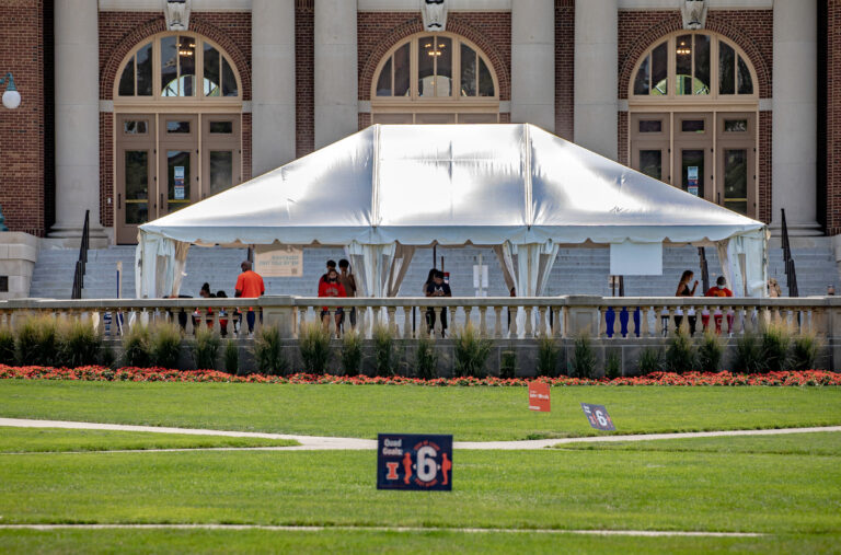 cvovid testing tent site with students taking saliva tests