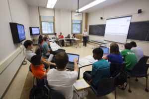 Teacher teaching in classroom using classroom technology
