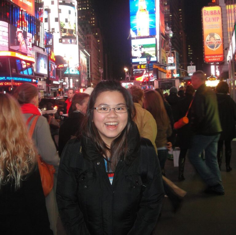 Picture of Julian Chin smiling with a city backdrop