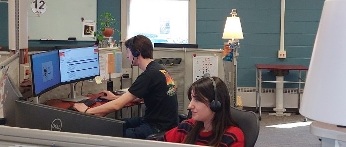 Image of 2 students working at the Technology Services Help Desk